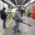 A specialist wearing protective gear sprays disinfectant inside the FOOD CITY wholesale and retail market to prevent the spread of the coronavirus disease (COVID-19) in Moscow, Russia April 9, 2020. Andrey Nikerichev/Moscow News Agency/Handout via REUTERS