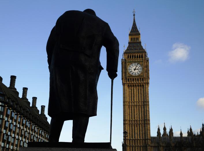 The statue of Britain's former Prime Minister Winston Churchill is silhouetted in front of the Houses of Parliament in London.